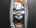 Framed 3D layered art piece featuring a detailed portrait of a creepy, stitched killer doll with bright orange hair and a menacing smile peeking out from behind dark window blinds.