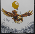 Framed 3D layered art piece featuring a charming illustration of a brown owl with outstretched wings flying while holding the string of a glossy yellow balloon in its beak. Below the owl is a detailed monochromatic, black-and-white sketch of a fairy tale village with vintage houses and lush trees.