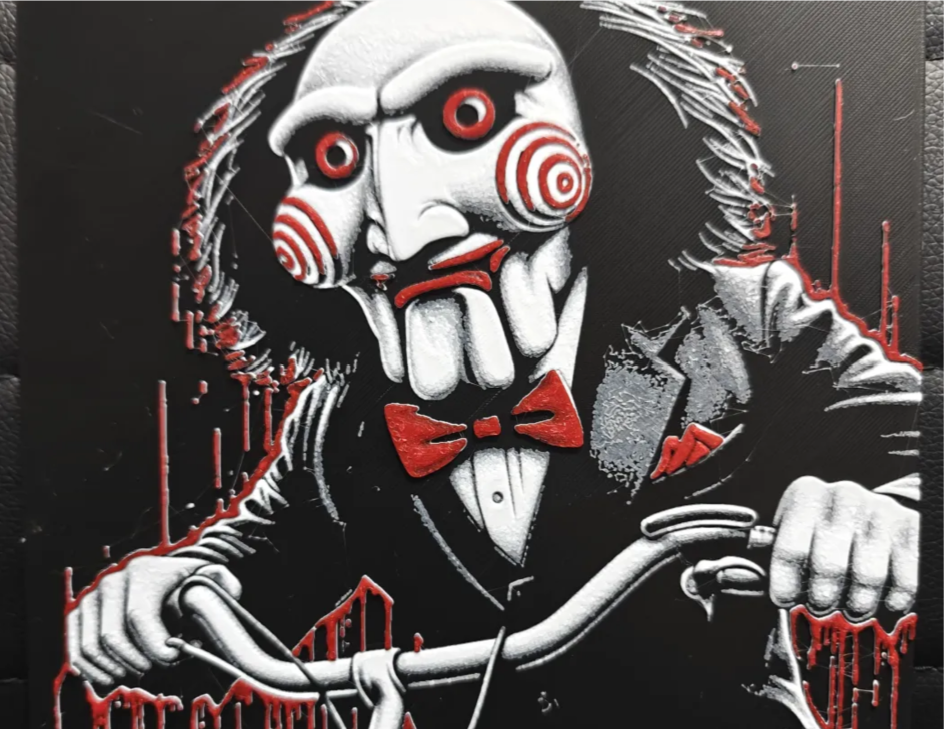 Saw puppet horror framed layered 3D art with red spiral cheeks and bow tie