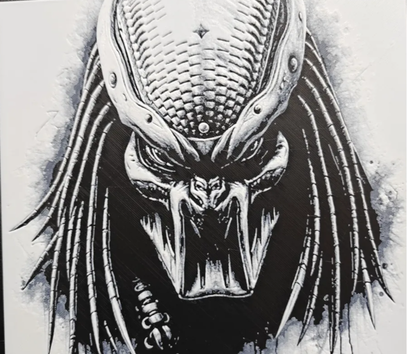 Framed 3D layered art piece featuring a highly detailed grayscale illustration of an iconic sci-fi alien hunter with metallic dreadlocks and a menacing bio-mask helmet showing open mandibles.