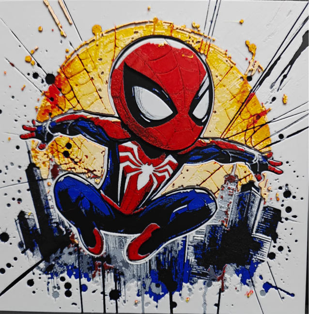 Framed 3D layered art piece visible in image_41fdfe.png featuring a dynamic chibi illustration of a classic red and blue spider hero character with a prominent white spider emblem on his chest, leaping in mid-air against a vibrant abstract background with a large yellow circle, city silhouettes, and paint splatters.