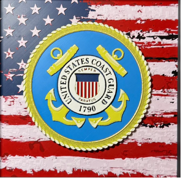 Framed 3D layered art piece featuring U.S. Coast Guard emblem over stylized American flag art in red white and blue
