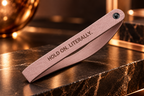 Pale pink wristlet engraved 'Hold On. Literally.'